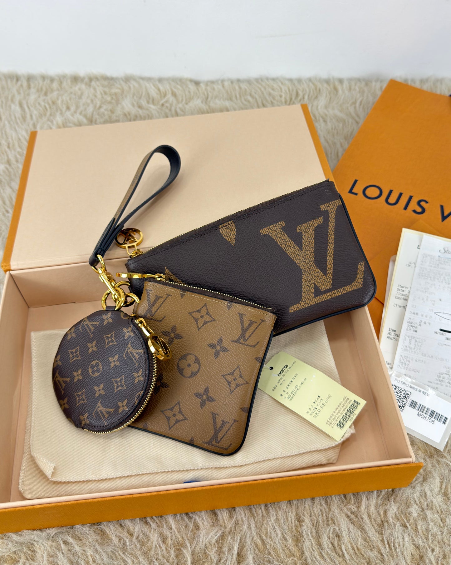 Louis Vuitton 
Monogram Giant Reverse Trio Pouch
