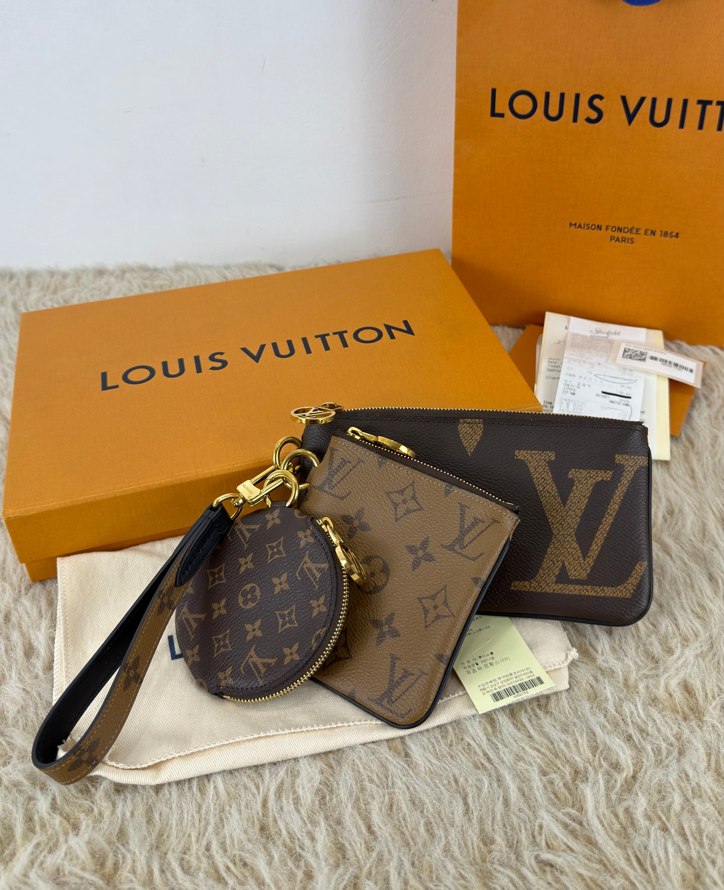 Louis Vuitton 
Monogram Giant Reverse Trio Pouch