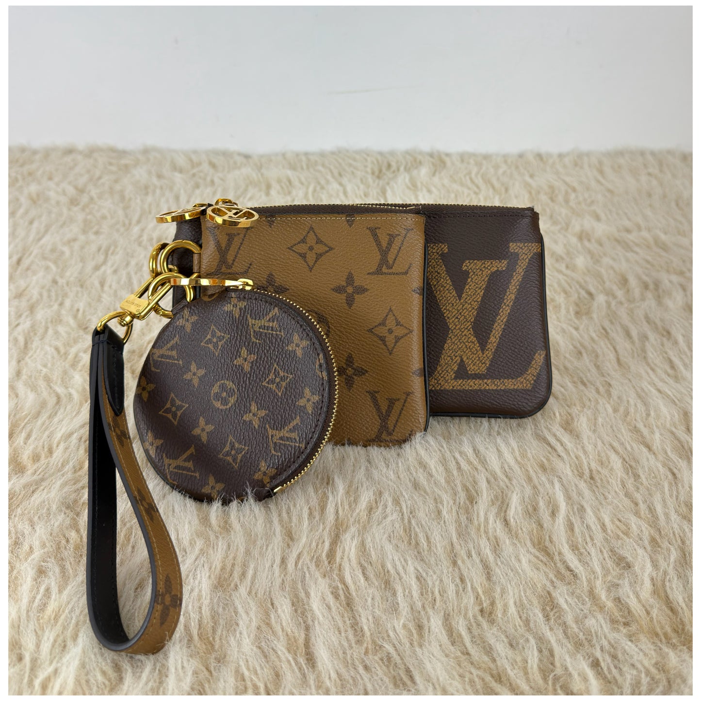 Louis Vuitton 
Monogram Giant Reverse Trio Pouch